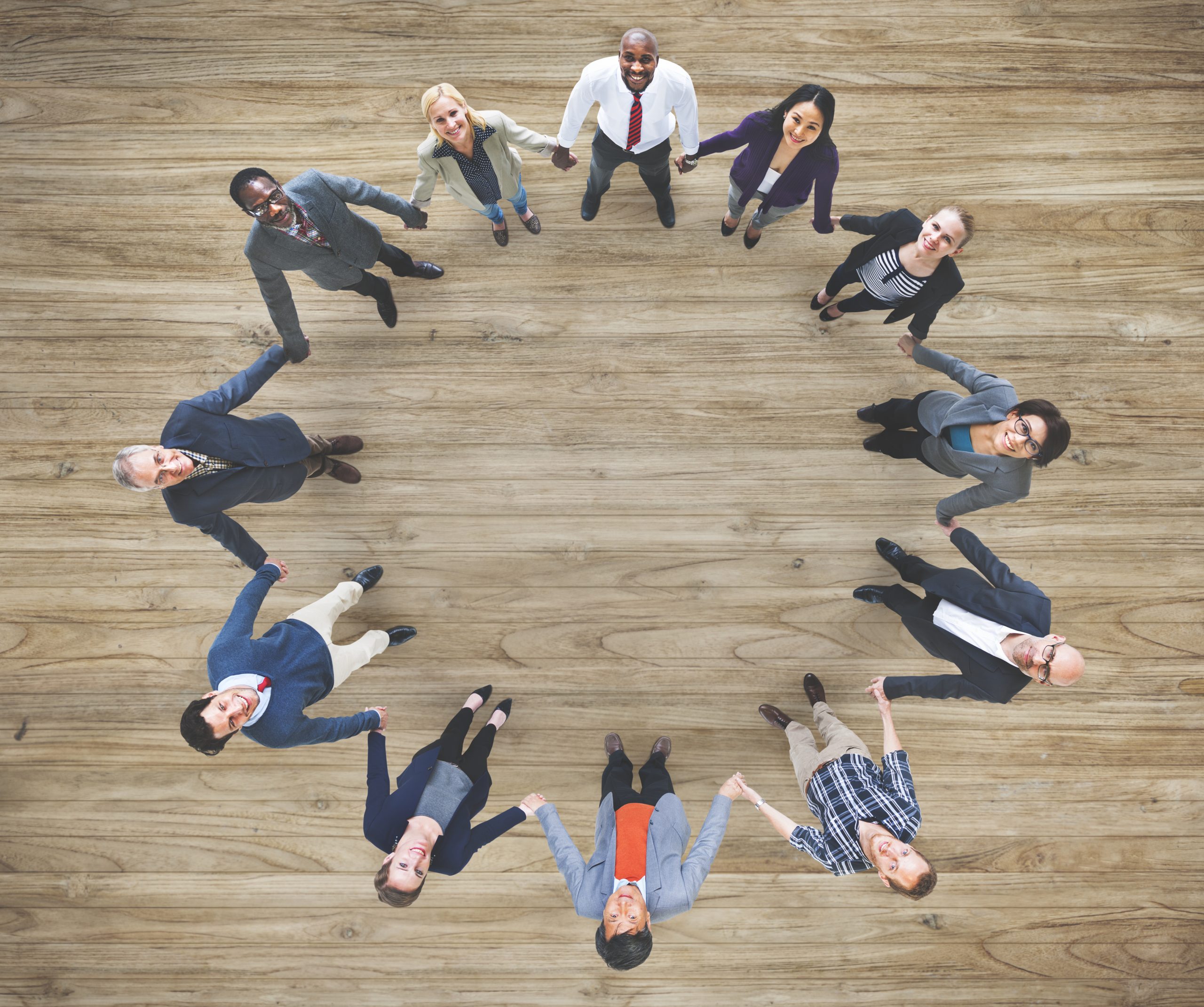 Aerial view of diverse business people holding hands togeher teamwork